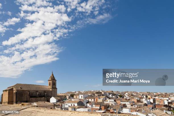 view of the picturesque village of sabiote. white houses and the church of san pedro. in the province of jaén. andalusia, spain - jaen province stockfoto's en -beelden