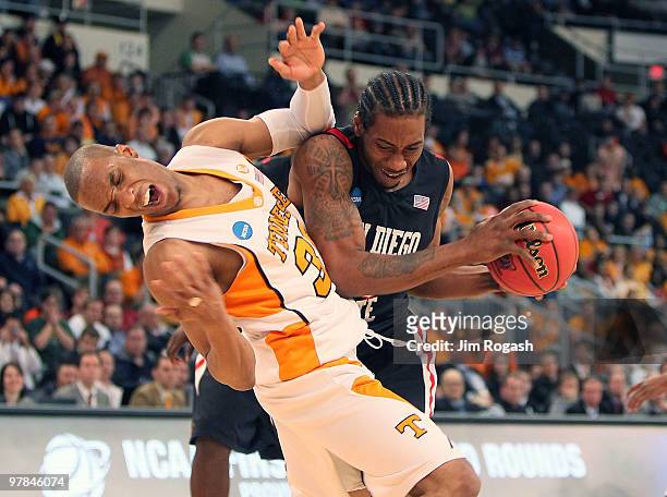 Kawhi Leonard of San Diego State Aztecs collides with J.P. Prince of Tennessee Volunteers during the first round of the 2010 NCAA men's basketball...