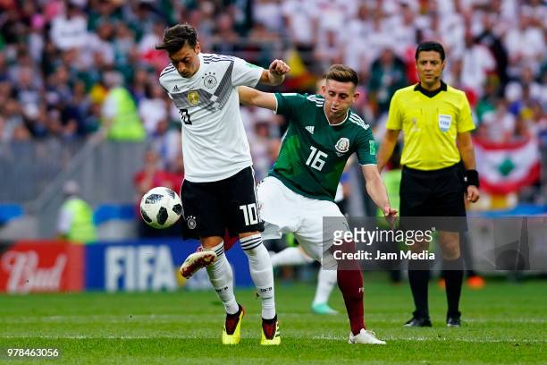 Mesut Ozil of Alemania and Hector Herrera of Mexico fight for the ball during the 2018 FIFA World Cup Russia group F match between Germany and Mexico...