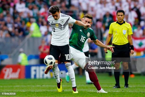Mesut Ozil of Alemania and Hector Herrera of Mexico fight for the ball during the 2018 FIFA World Cup Russia group F match between Germany and Mexico...