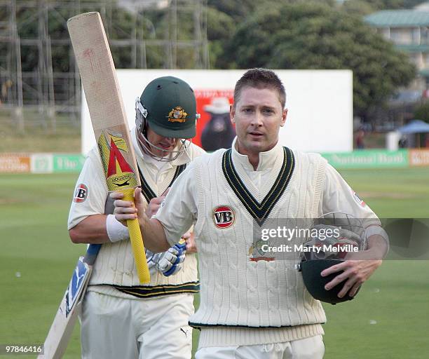 Michael Clarke of Australia walks from the field at the end of the days play with team mate Marcus North during day one of the First Test match...