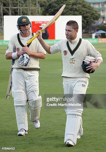 Michael Clarke of Australia walks from the field at the end of the days play with team mate Marcus North during day one of the First Test match...