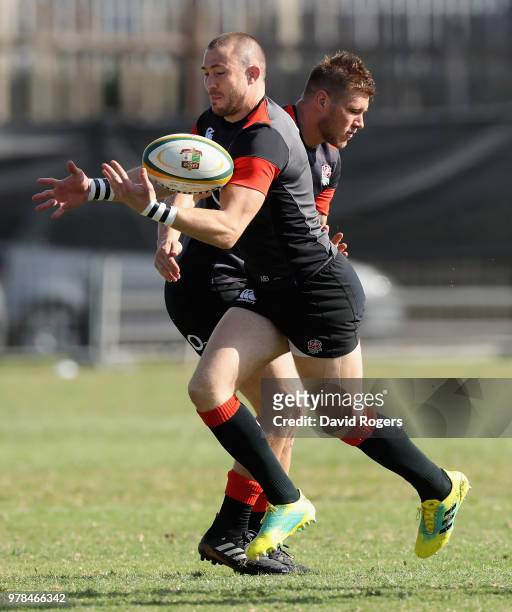 Mike Brown catches the ball as team mate Jason Woodward tackles during the England training session held at Kings Park on June 19, 2018 in Durban,...