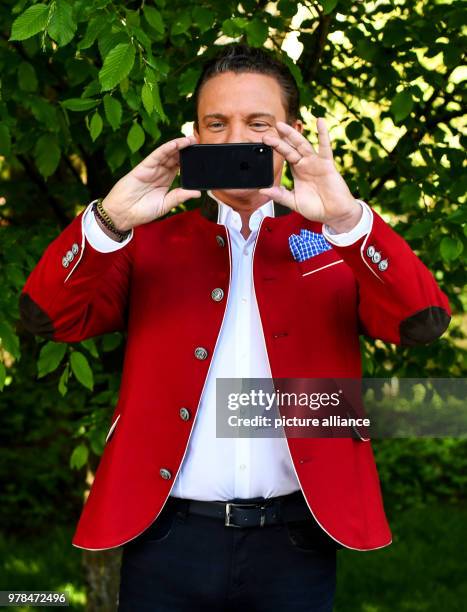 April 2018, Rust, Germany: Musician and Moderator Setfan Mross taking a picture of the photographers at the Europa Park after a press conference of...