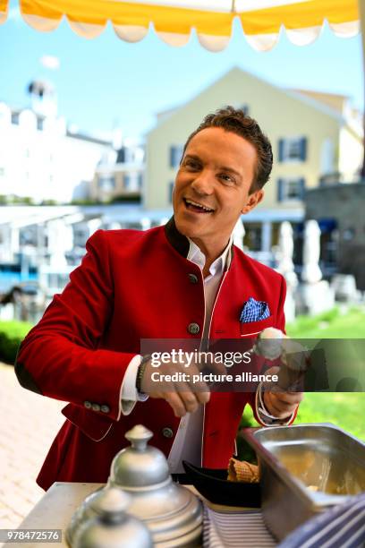 April 2018, Rust, Germany: Musician and Moderator Setfan Mross at an Ice-cream booth in Europa Park after the this year's press conference of the...