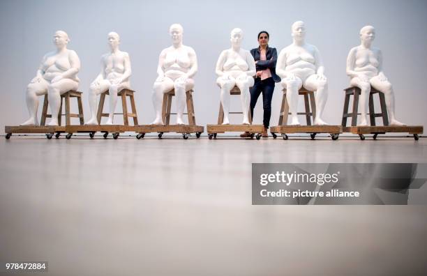 April 2018, Germany, Wolfsburg: Indian artist Bharti Kher standing hehind her piece "Six Women". The exhibition "Facing India" at the Kunstmuseum...