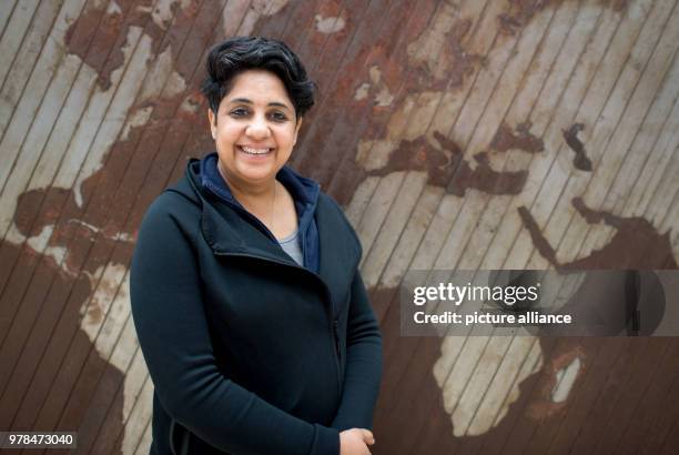 Indian artist Vibha Galhotra poses in front of her work "Time Symphony or Cacophony" during the exhibition "Facing India", which tackles the feminine...