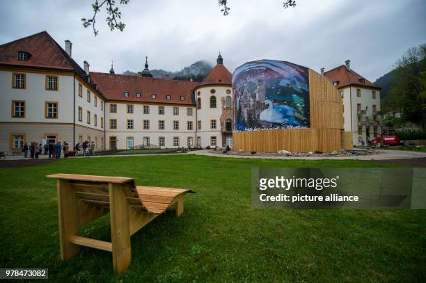 April 2018, Germany, Ettal: A wooden bench near the "Holz erleben" pavillion in the grounds of Ettal Abbey. The Bayerische Landesausstellung 2018 is...