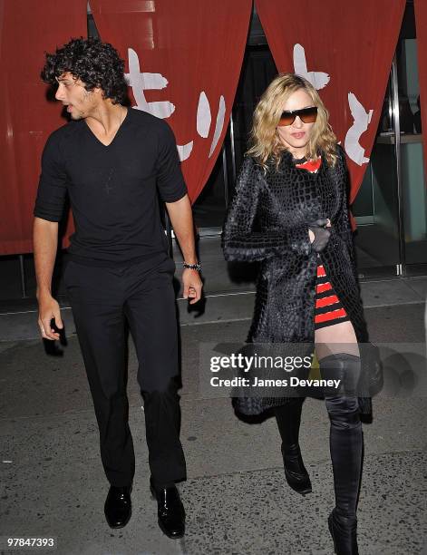 Jesus Luz and Madonna are seen leaving Morimoto in the Meatpacking District on March 18, 2010 in New York City.