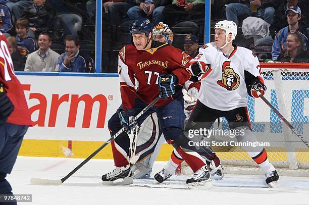 Pavel Kubina of the Atlanta Thrashers battles for position against Chris Neil of the Ottawa Senators at Philips Arena on March 18, 2010 in Atlanta,...