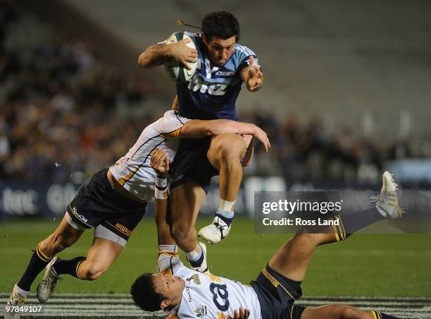Rene Ranger of the Blues steps through the tackle Christiann Lealiifano of the Brumbies during the round six Super 14 match between the Blues and the...