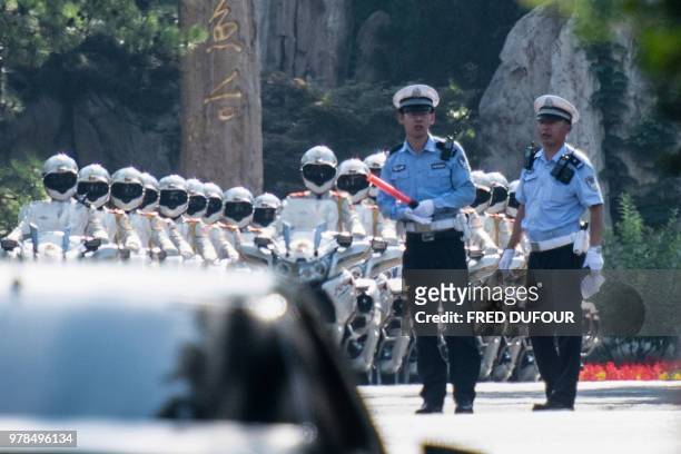 Chinese bikers honour guards prepare to escort the car believed to be carrying North Korean leader Kim Jong Un at the Diaoyutai State Guest house...