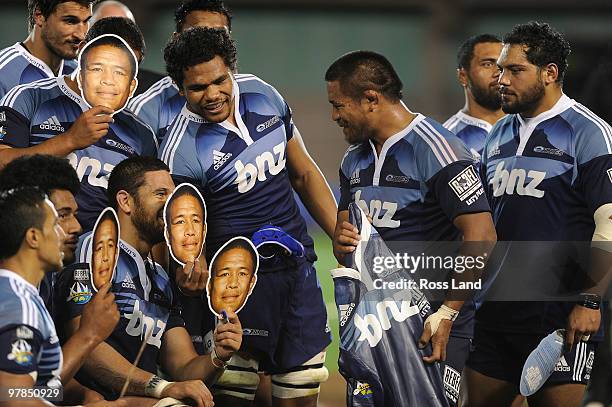 Keven Mealamu of the Blues is surrounded by team mates holding masks after he was presented with a carved wooden gersey for playing his 100th Super...