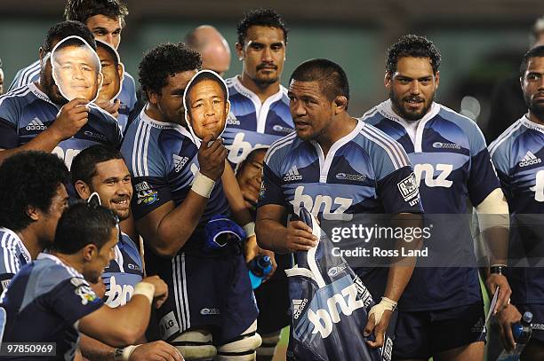 Keven Mealamu of the Blues is surrounded by team mates holding masks after he was presented with a carved wooden gersey for playing his 100th Super...