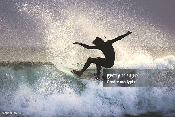 surfer on the lip of a wave - mollypix stock pictures, royalty-free photos & images