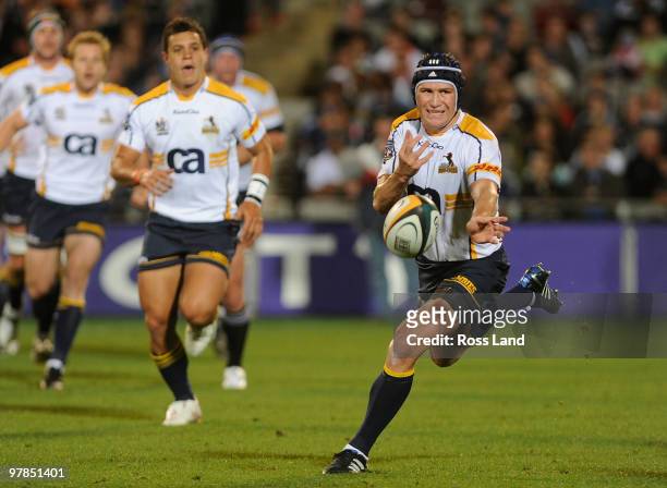 Matt Giteau of the Brumbies offloads the ball during the round six Super 14 match between the Blues and the Brumbies at Eden Park on March 19, 2010...