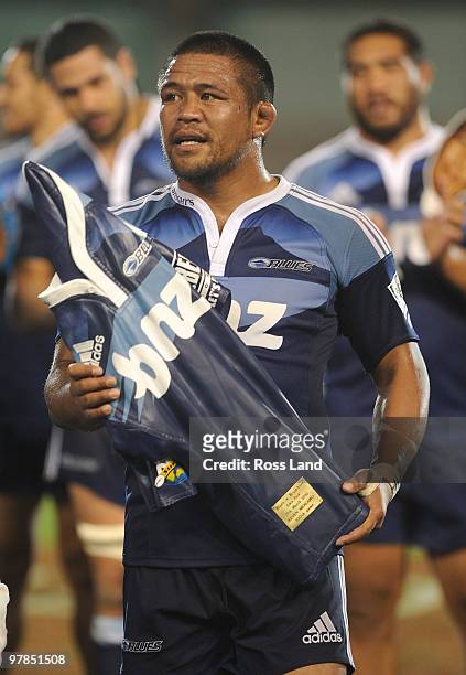 Keven Mealamu of the Blues is presented with a carved wooden jersey for playing his 100th Super Rugby match in the round six Super 14 match between...
