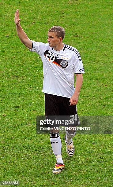 German forward Lukas Podolski waves to supporters as he leaves the pitch after Croatia defeated Germany in the Euro 2008 Championships Group B...