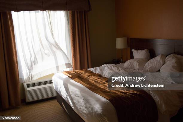 Drapes from a hotel room window catch the breeze of an air conditioner on May 10, 2018 in El Paso, Texas.