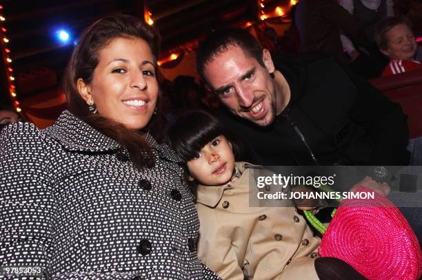 Bayern Munich's French midfielder Franck Ribery, his wife Wahiba and their daughter pose as they arrive to attend the FC Bayern Circus Gala at the...