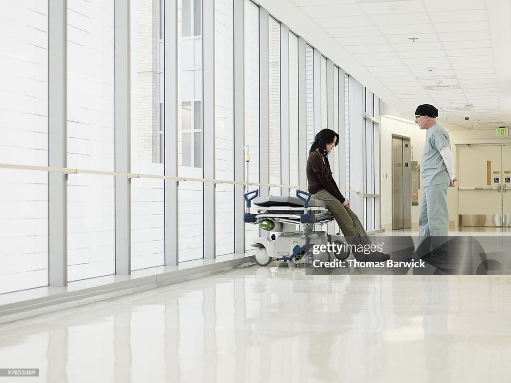 Female in discussion with surgeon in hospital hall