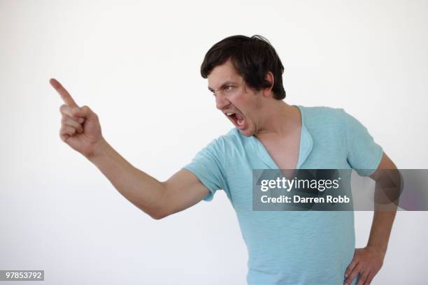 young man pointing his finger, shouting - shout stock pictures, royalty-free photos & images