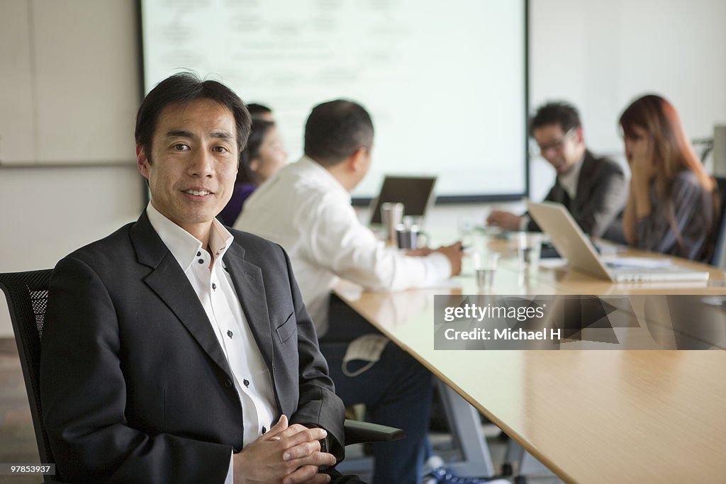 Businessman's portrait under meeting