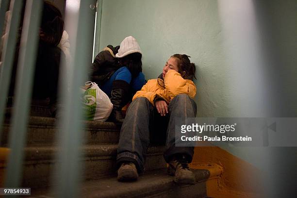 Sainaa tries to get some sleep on a cold stairwell with other friends inside an apartment building March 15, 2010 in Ulaan Baatar, Mongolia. Nandia...