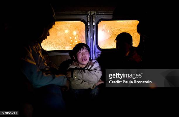 Mongolian police capture a boy as they round up street kids to get them out of the cold March 11, 2010 in Ulaan Baatar, Mongolia. The police take the...