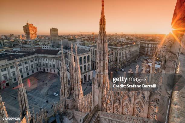 milan old town square at sunset seen from milan cathedral, milan, lombardy, italy - milan cathedral - fotografias e filmes do acervo