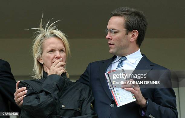 James Murdoch , son of media mogul Rupert Murdoch, gestures toward his sister Elisabeth Murdoch as they stand in a balcony overlooking the racing...