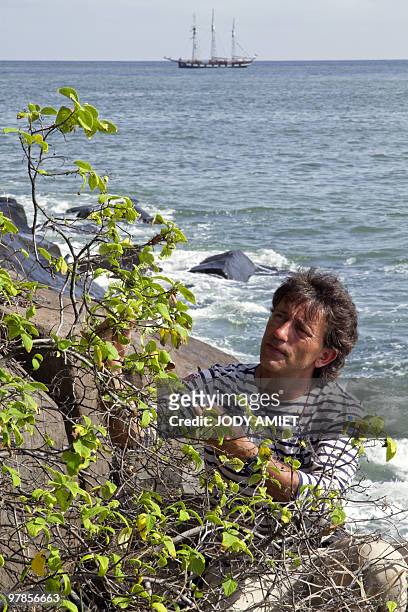 French botanical researcher Bruno Bordenave examines a plant on Royal Island, the largest of the Islands of Salvation in the Caribbean Sea off French...