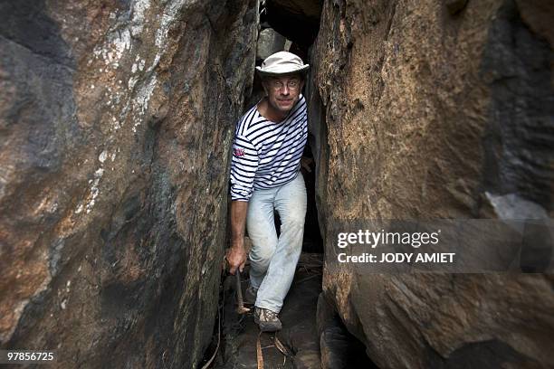 French geologist Eric Gilli walks as he examines rocks to find trail of a possible tsunami in 1855 in the Iles du Salut in French Guiana, about 10...