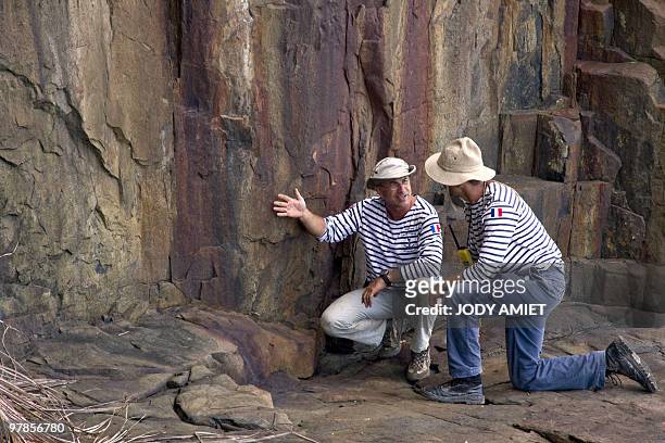French geologist Eric Gilli examines a rock to find trail of a possible tsunami in 1855 in the Iles du Salut in French Guiana, about 10 miles from...