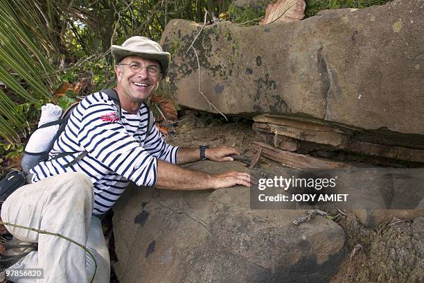 French geologist Eric Gilli examines a rock to find trail of a possible tsunami in 1855 in the Iles du Salut in French Guiana, about 10 miles from...