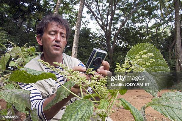 French botanical researcher Bruno Bordenave takes a pictute of a plant on Royal Island, the largest of the Islands of Salvation in the Caribbean Sea...