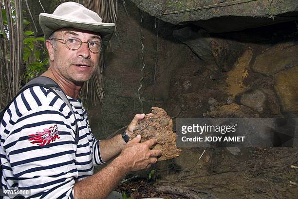 French geologist Eric Gilli examines a rock to find trail of a possible tsunami in 1855 in the Iles du Salut in French Guiana, about 10 miles from...