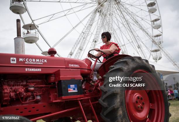 Woman drives a vintage tractor on the first day of The Royal Cheshire County Show at Tabley, near Knutsford, northern England on June 19, 2018. - The...