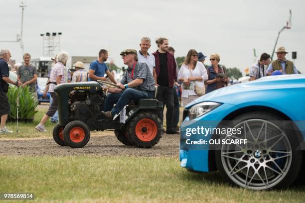 Man drives a small vintage tractor through the showground on the first day of The Royal Cheshire County Show at Tabley, near Knutsford, northern...