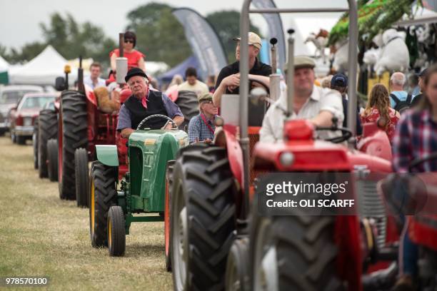 Exhibitors drive their vintage tractors through the showground on the first day of The Royal Cheshire County Show at Tabley, near Knutsford, northern...