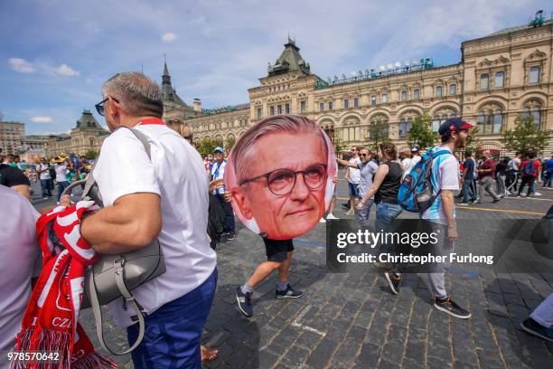 Man carries a giant picture of Poland's manager Adam Nawalka as Polish football fans gather in Red Square and sing before their World Cup game...