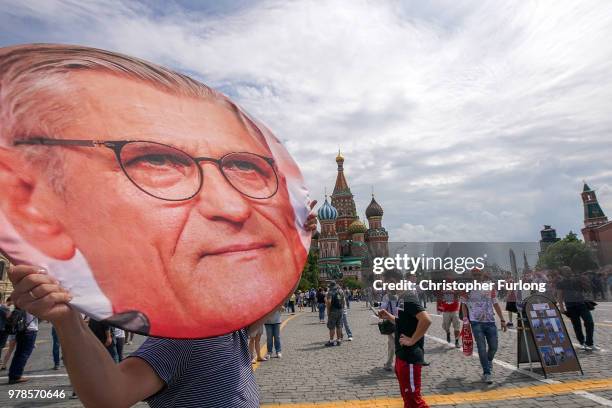 Man carries a giant picture of Poland's manager Adam Nawalka as Polish football fans gather in Red Square and sing before their World Cup game...