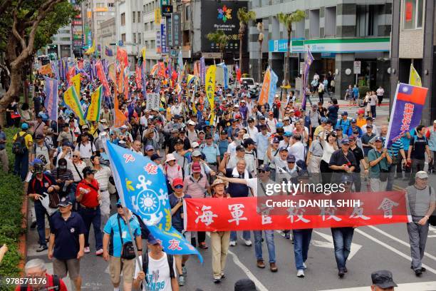 Taiwanese military veterans march along a street during a protest near parliament building against a pension reform bill in Taipei June 19, 2018. -...