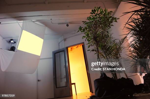 By Sebastian Smith, Lifestyle-art-exhibition-offbeat-film-environment Video scenes of the sky are projected through a scrim onto seven plants in...