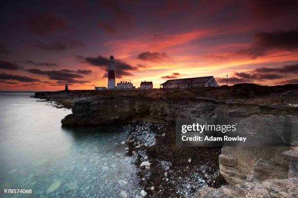 sunset over portland bill lighthouse, dorset, england, uk - beach england stock pictures, royalty-free photos & images