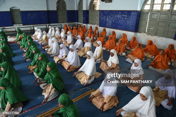 Indian students from Anjuman-E-Islam school participate in a rehearsal yoga session ahead of International Yoga Day in Ahmedabad on June 19, 2018. -...