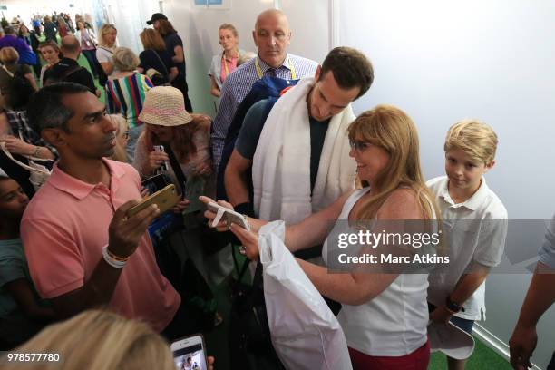 Andy Murray poses with fans as he leaves the practice courts during Day 2 of the Fever-Tree Championships at Queens Club on June 19, 2018 in London,...