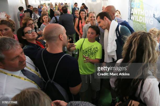 Andy Murray poses with fans as he leaves the practice courts during Day 2 of the Fever-Tree Championships at Queens Club on June 19, 2018 in London,...