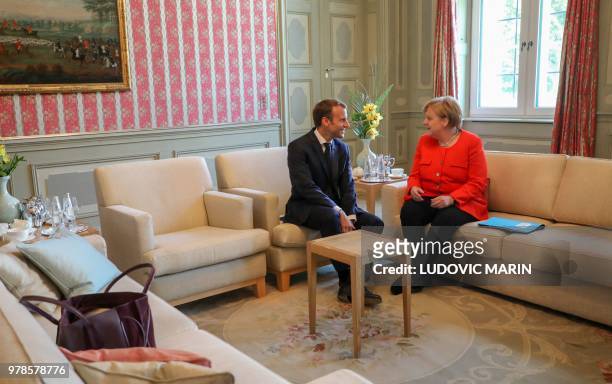 German Chancellor Angela Merkel and French President Emmanuel Macron holdbilateral talks on June 19 at the Meseberg Palace, north of Berlin, during a...