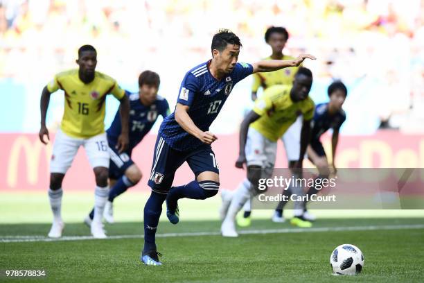 Shinji Kagawa of Japan scores his team's first goal from the penalty spot during the 2018 FIFA World Cup Russia group H match between Colombia and...